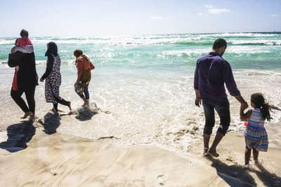 Men walking on beach