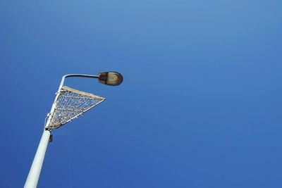 Low angle view of basketball hoop against blue sky