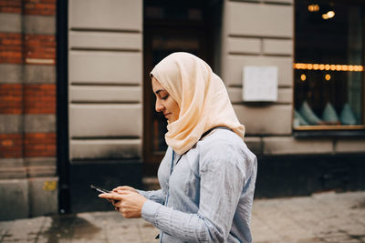 Side view of man using smart phone