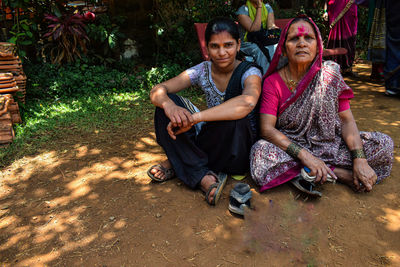 Women sitting on wall