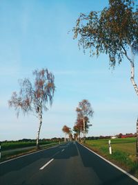 Road passing through landscape against sky