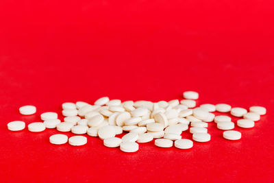 Close-up of pills over yellow background