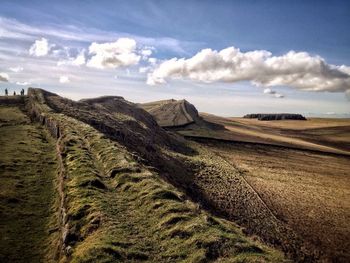 Scenic view of landscape against cloudy sky