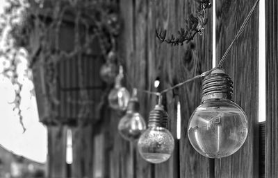 Close-up of light bulb hanging on wall