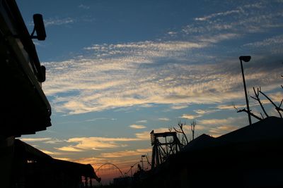 Low angle view of building against cloudy sky