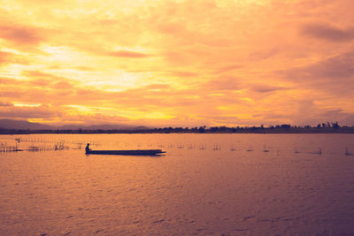 Scenic view of sea against orange sky