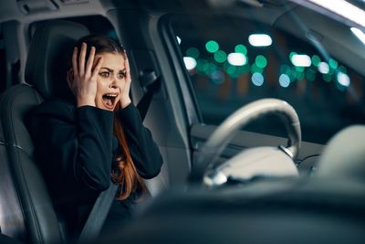 Woman screaming sitting in car