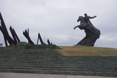 Low angle view of statue against sky