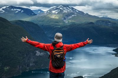 Rear view of person standing on snow covered mountain