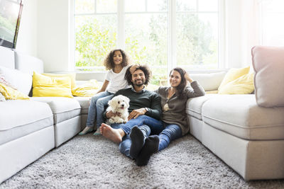 Portrait of friends sitting on sofa