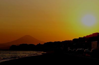 Scenic view of silhouette mountains against romantic sky at sunset