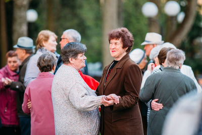 Rear view of people standing outdoors