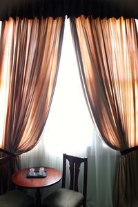 Chairs and table by window at home