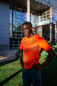 Young man standing against wall