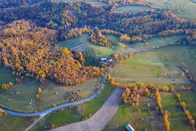 Aerial picture of a countryside village road, agricultural fields by drone. transylvania, romania