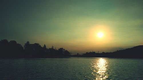 Scenic view of lake against sky during sunset