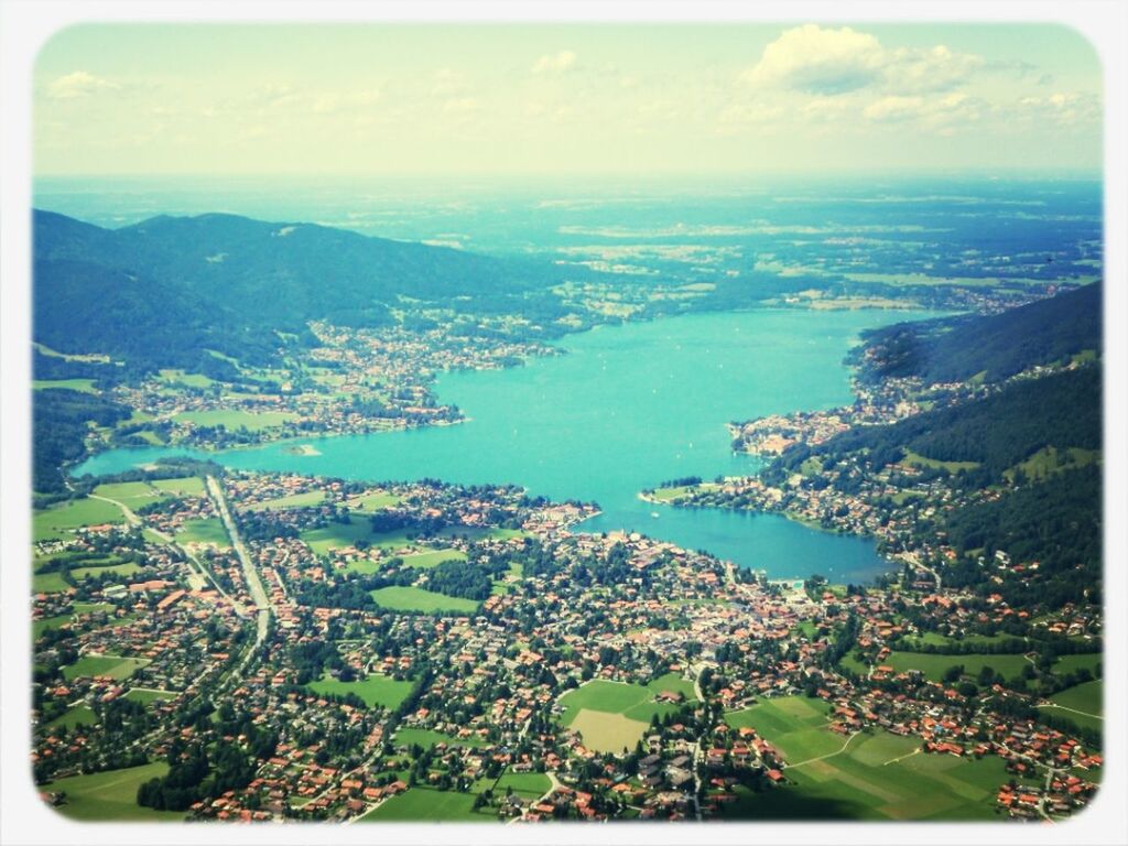 transfer print, sea, high angle view, cityscape, water, aerial view, auto post production filter, horizon over water, architecture, built structure, building exterior, sky, city, coastline, crowded, mountain, scenics, town, nature, elevated view