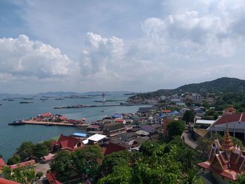 High angle view of townscape by sea against sky