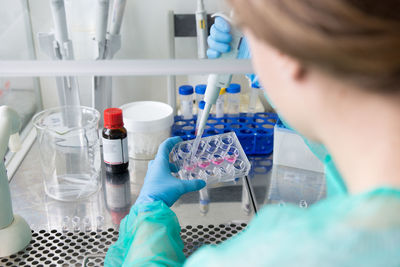 Researchers in the medical laboratory process the samples for vi