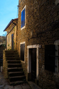 Staircase by house against sky