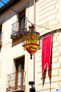 Low angle view of lantern hanging from window