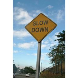 Low angle view of road sign against sky