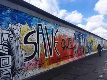 Graffiti on wall against sky