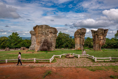 Rear view of woman against cloudy sky