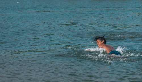 Boys swimming in sea