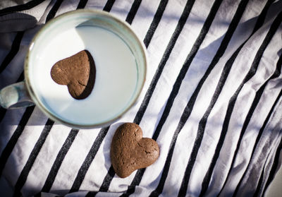 High angle view of coffee and cookies on table