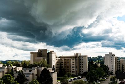 View of residential district against cloudy sky