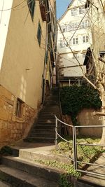 Low angle view of steps amidst buildings in town