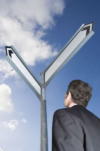 Low angle view of man standing against sky