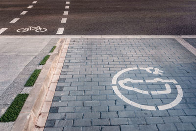 High angle view of arrow sign on road in city