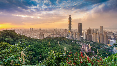 Panoramic view of buildings in city during sunset