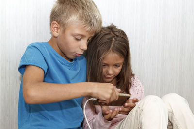 Mother and daughter sitting in bedroom