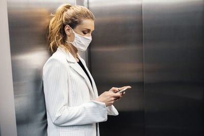 Midsection of woman using mobile phone