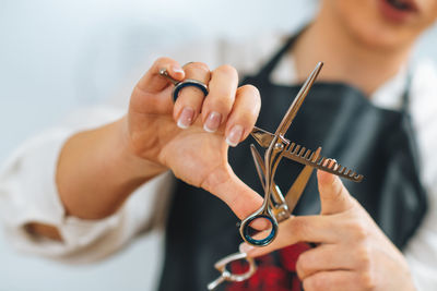 Hand of a hairdresser holding hairdressing scissors, explaining students haircutting techniques 