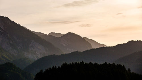 Scenic view of silhouette mountains against sky at sunset