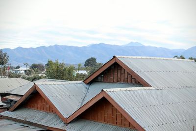 Houses against mountain range