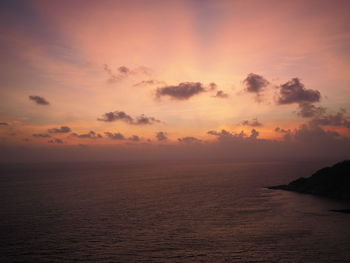 Scenic view of sea against romantic sky at sunset