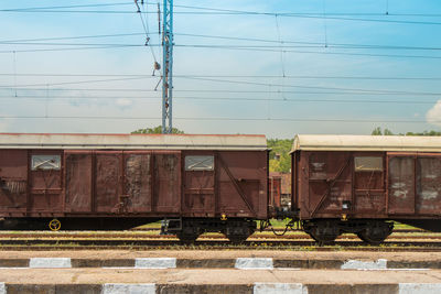 Train at railroad station against sky