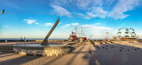 Panoramic view of pier on beach against sky