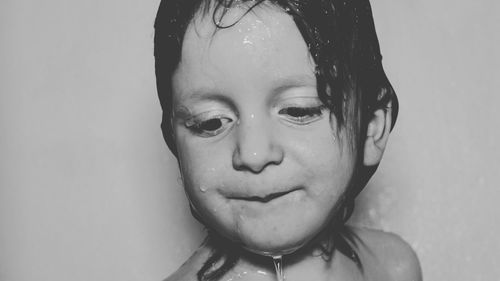 Close-up portrait of shirtless boy in bathroom