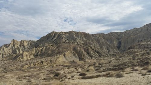 Scenic view of arid landscape against sky