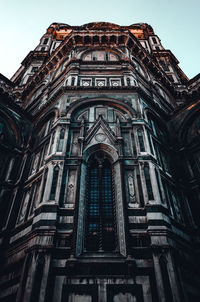 Low angle view of tower against sky in city