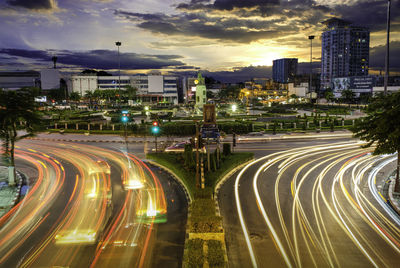 Light trails on road against sky at night