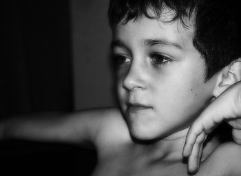 Close-up portrait of shirtless boy at home