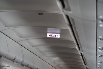 Low angle view of illuminated sign on ceiling
