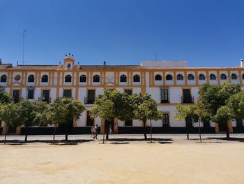 Low angle view of historical building against clear blue sky